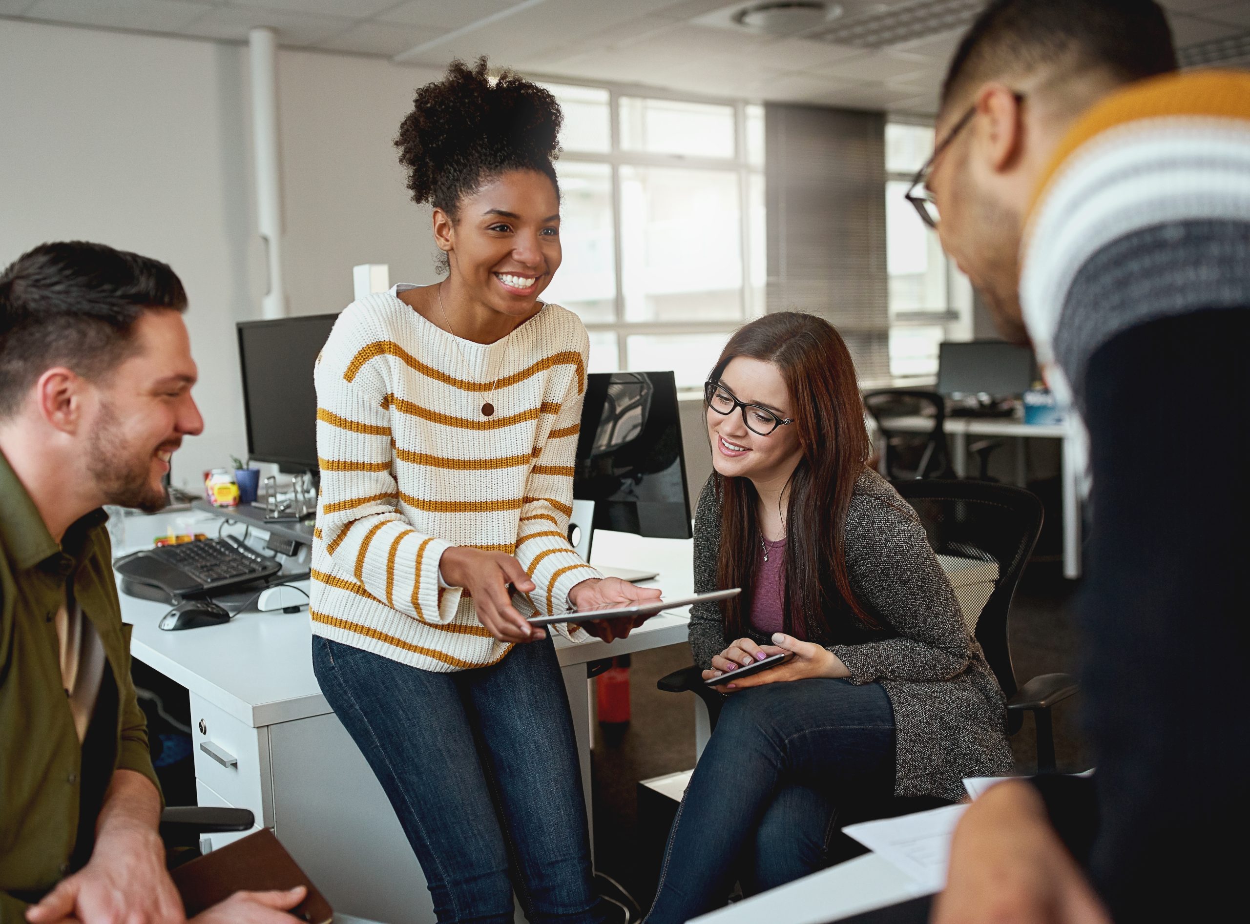 group of people working together in an office setting